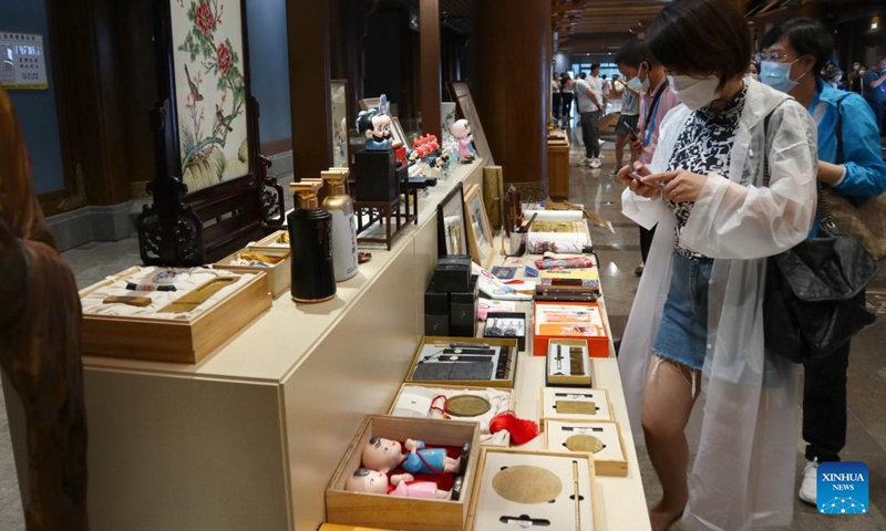 Visitors look at various products during a culture and tourism commodities fair in Qufu of Jining, east China's Shandong Province, June 27, 2022. A culture and tourism commodities fair to promote culture and tourism industry in Shandong Province is held here Monday.(Photo: Xinhua)
