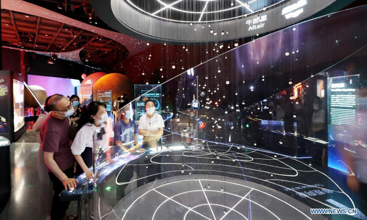 Visitors look at exhibits in Shanghai Astronomy Museum during a media preview in east China's Shanghai, July 5, 2021. The Shanghai Astronomy Museum, the world's largest planetarium in terms of building scale, will open on July 17, the planetarium announced Monday. The museum is located in the China (Shanghai) Pilot Free Trade Zone Lingang Special Area. It is a branch of the Shanghai Science and Technology Museum. Photo: Xinhua