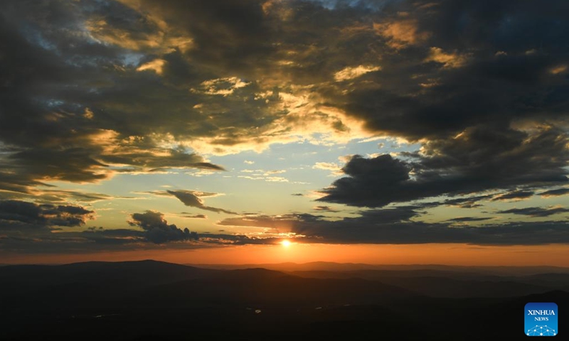 Photo taken on June 28, 2022 shows the sunset at Okliet Mountain in Genhe City, north China's Inner Mongolia Autonomous Region.(Photo: Xinhua)