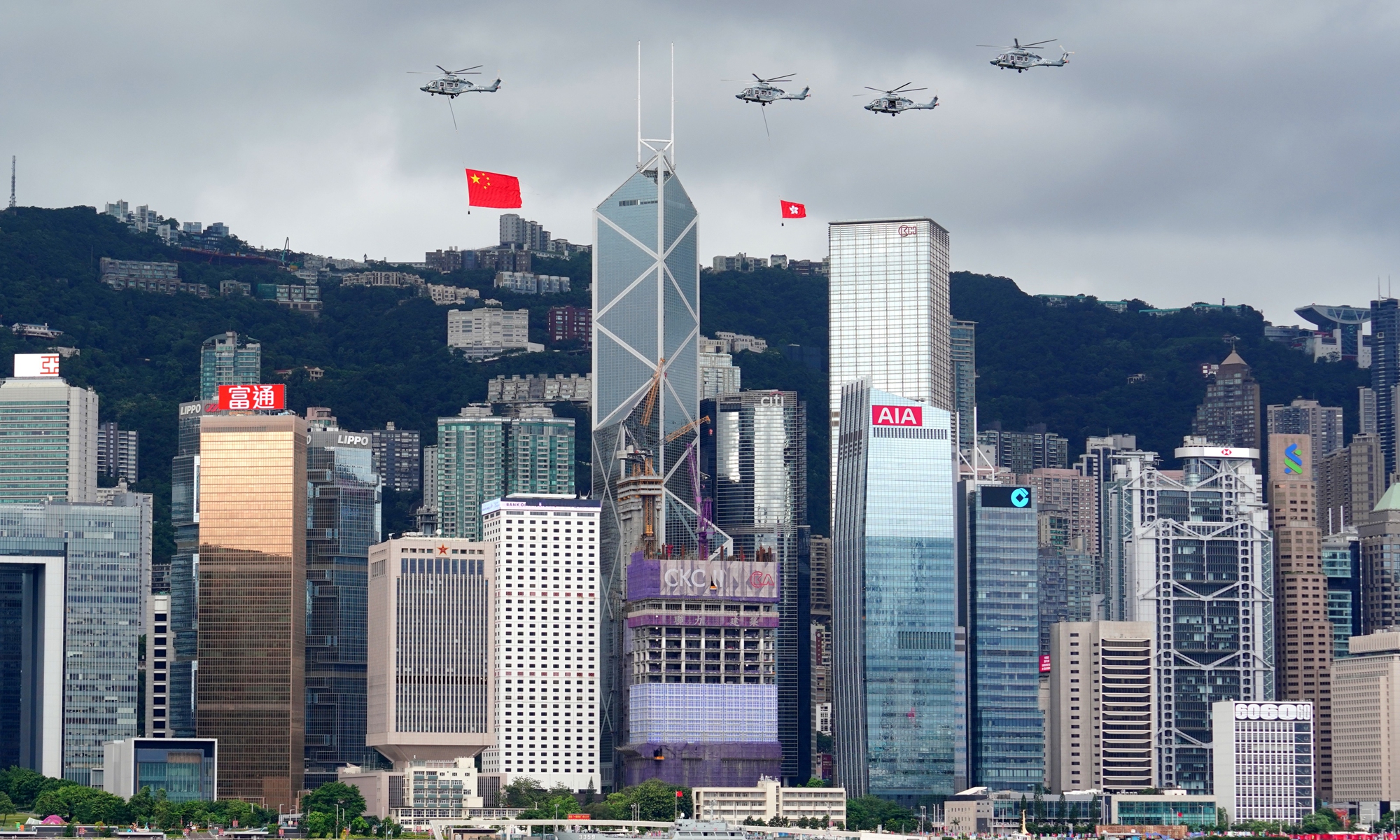 Helicopters displaying the Chinese national flag and the Hong Kong regional flag fly over Victoria Harbour during celebrations of the 25th anniversary of Hong Kong’s return to the motherland on July 1, 2022. Photo: cnsphoto