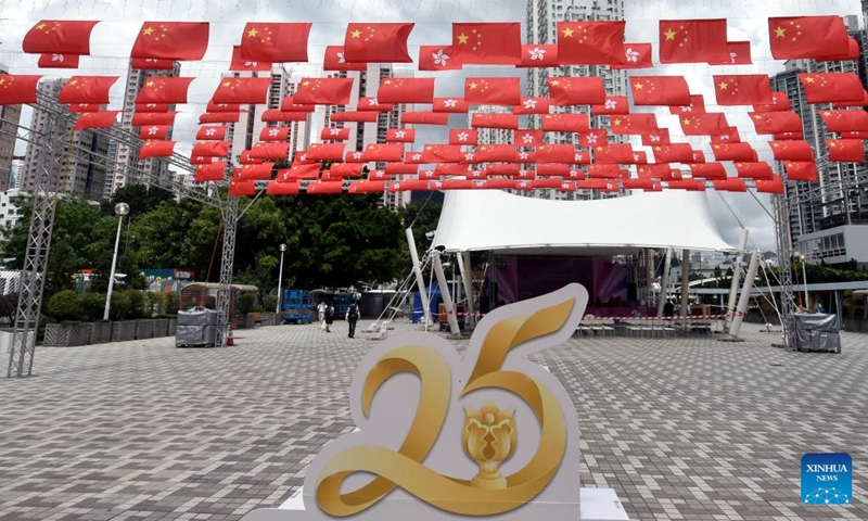 China's national flags and the Hong Kong Special Administrative Region (HKSAR) flags fly along a street in Hong Kong, south China, June 29, 2022. July 1 this year marks the 25th anniversary of Hong Kong's return to the motherland.(Photo: Xinhua)