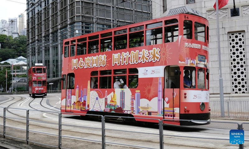 A bus painted with posters marking the 25th anniversary of Hong Kong's return to the motherland runs in Hong Kong, south China, June 30, 2022. July 1 is the celebration day for the 25th anniversary of Hong Kong's return to the motherland.(Photo: Xinhua)