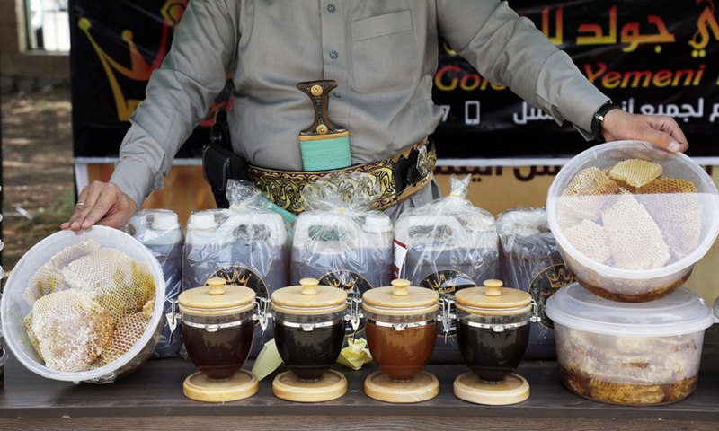 A seller displays his honey products at a honey festival in Sanaa, capital of Yemen, on June 30, 2022.(Photo: Xinhua)