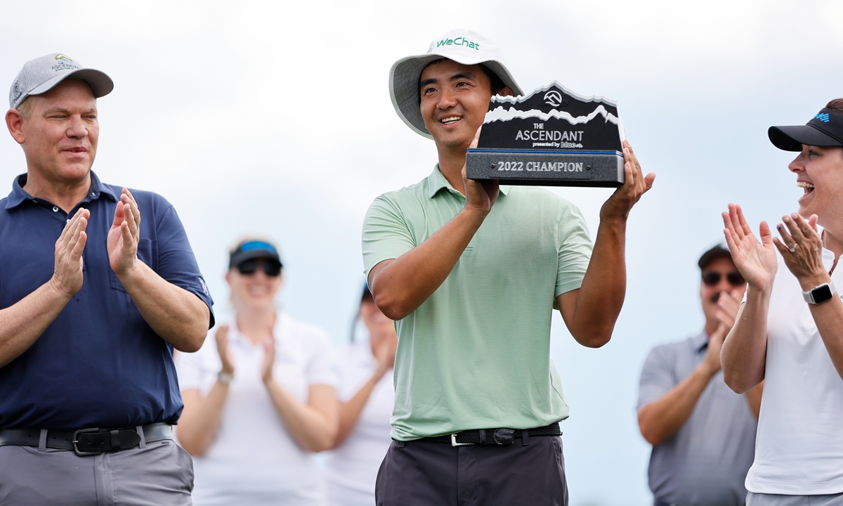 Dou Zecheng hoists the trophy after winning the final round of The Ascendant presented by Blue at TPC Colorado on July 3, 2022 in Berthoud, Colorado. Photo: VCG