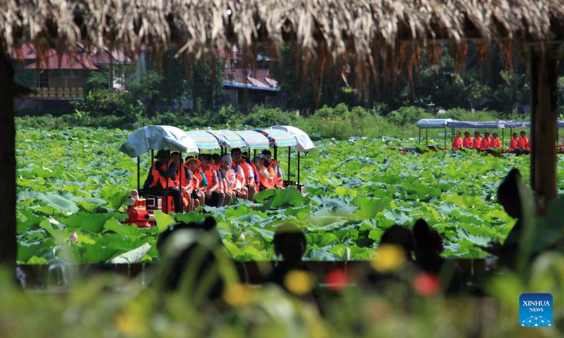 Visitors take sightseeing mini trains to enjoy lotus flowers at Longde Lake in Jinghong City of Xishuangbanna Dai Autonomous Prefecture, southwest China's Yunnan Province, July 2, 2022.Photo:Xinhua