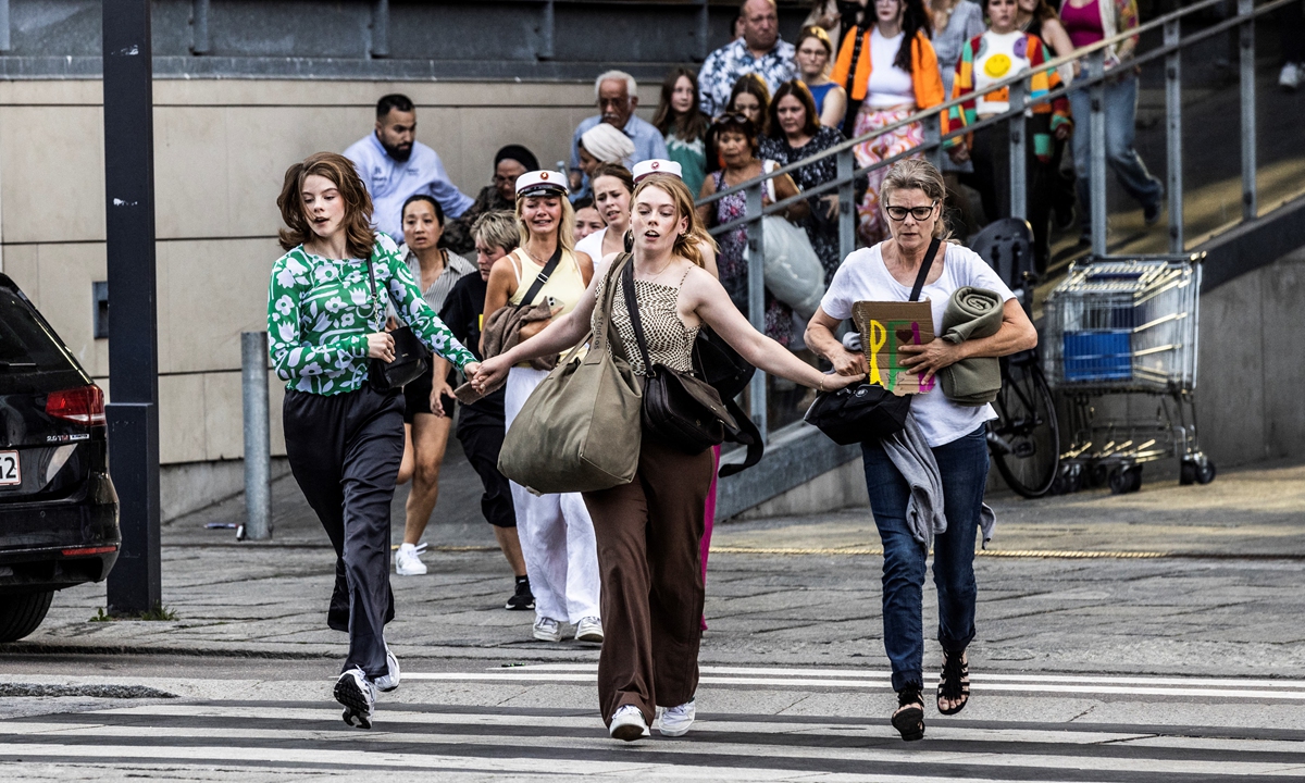 People leave the Fields shopping mall, where a gunman killed three people and wounded several others in Copenhagen, Denmark on July 3, 2022. Photo: AFP