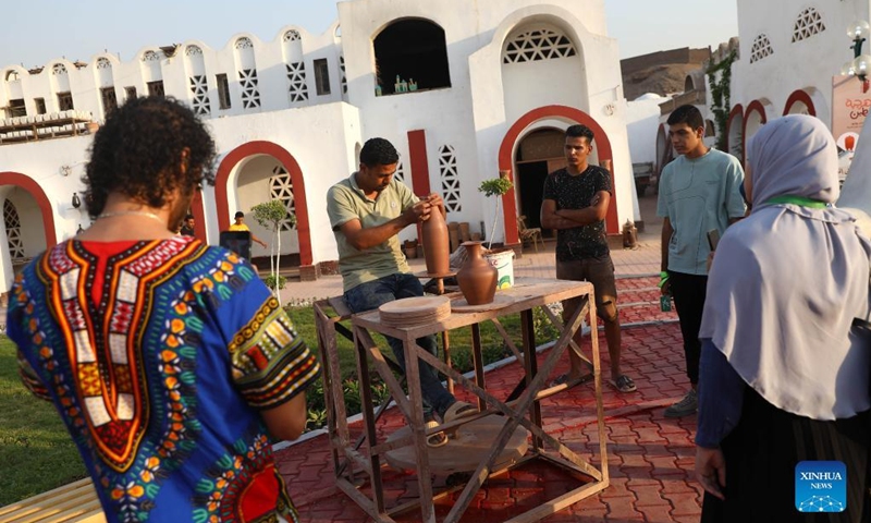 A craftsman shows pottery making techniques during a pottery exhibition at Fustat Pottery Village in Cairo, Egypt, July 3, 2022. A three-day pottery exhibition opened on Sunday at the Fustat Pottery Village, with the aim of promoting traditional Egyptian pottery culture and reviving pottery industry.(Photo: Xinhua)