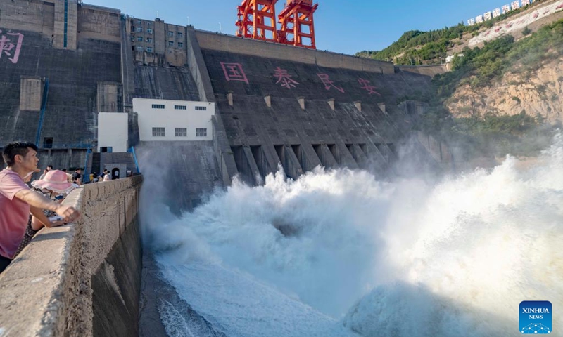 Photo taken on July 4, 2022 shows the Sanmenxia water control project during a water and sediment regulating operation in central China's Henan Province. Sanmenxia Reservoir has conducted the water and sediment regulating operation to clear out the mud and sand accumulated at the dam from July 4.(Photo: Xinhua)