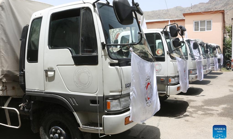Photo taken on July 3, 2022 shows trucks carrying earthquake relief supplies donated by the Red Cross Society of China (RCSC) at a handover ceremony in Kabul, Afghanistan. The Afghan Red Crescent Society (ARCS) has received earthquake relief supplies donated by the RCSC.(Photo: Xinhua)