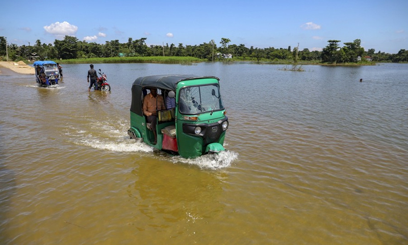 Rickshaws move through a flooded road in Sunamganj, Bangladesh, on July 3, 2022.(Photo: Xinhua)