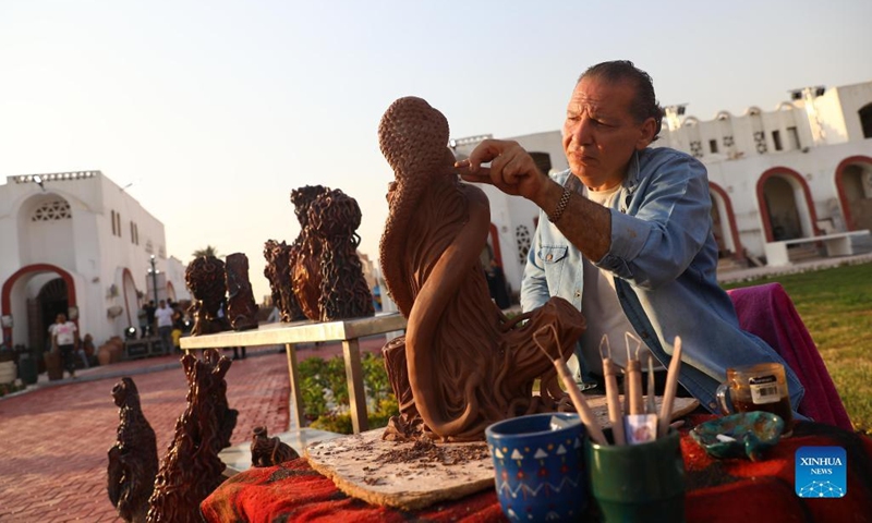 A craftsman makes pottery ware during a pottery exhibition at Fustat Pottery Village in Cairo, Egypt, July 3, 2022. A three-day pottery exhibition opened on Sunday at the Fustat Pottery Village, with the aim of promoting traditional Egyptian pottery culture and reviving pottery industry.(Photo: Xinhua)