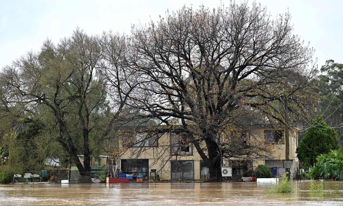 A general view shows a flooded residential area from the overflowing Nepean River due to torrential rain in western Sydney on July 5, 2022. Emergency services have now instructed about 50,000 people to evacuate or to prepare to escape the rising waters in New South Wales, officials said. Photo: AFP