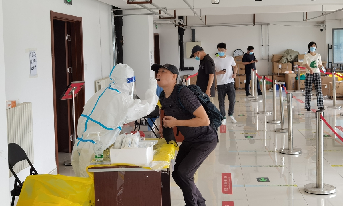 Residents from Shijingshan district in Beijing take nucleic acid tests on July 6, 2022. Photo: IC