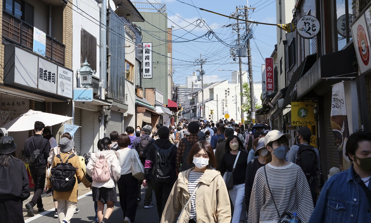 Tourists walk along a street in Kyoto, Japan, on May 3, 2022. Photo: VCG