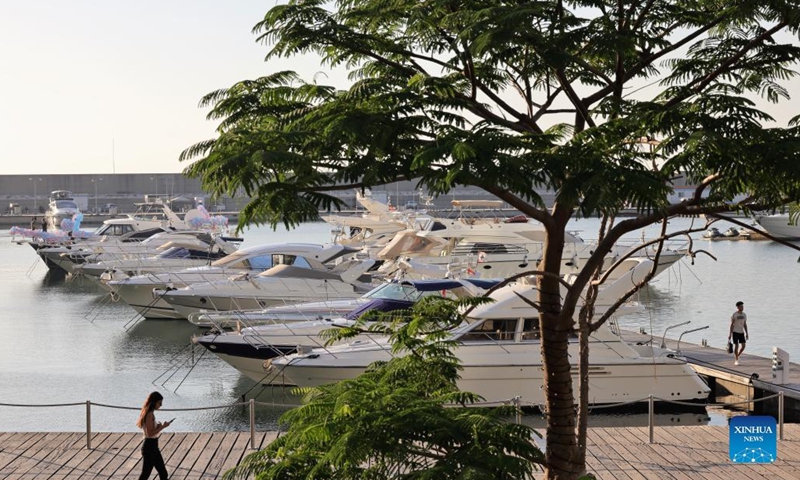 People walk in a marina in Beirut, Lebanon, on July 7, 2022. In the 2000s, Lebanon's boat industry saw glamorous times. However, the scene is completely different today. The Beirut Marina is half empty, let alone the other 14 marinas spreading across the country.(Photo: Xinhua)