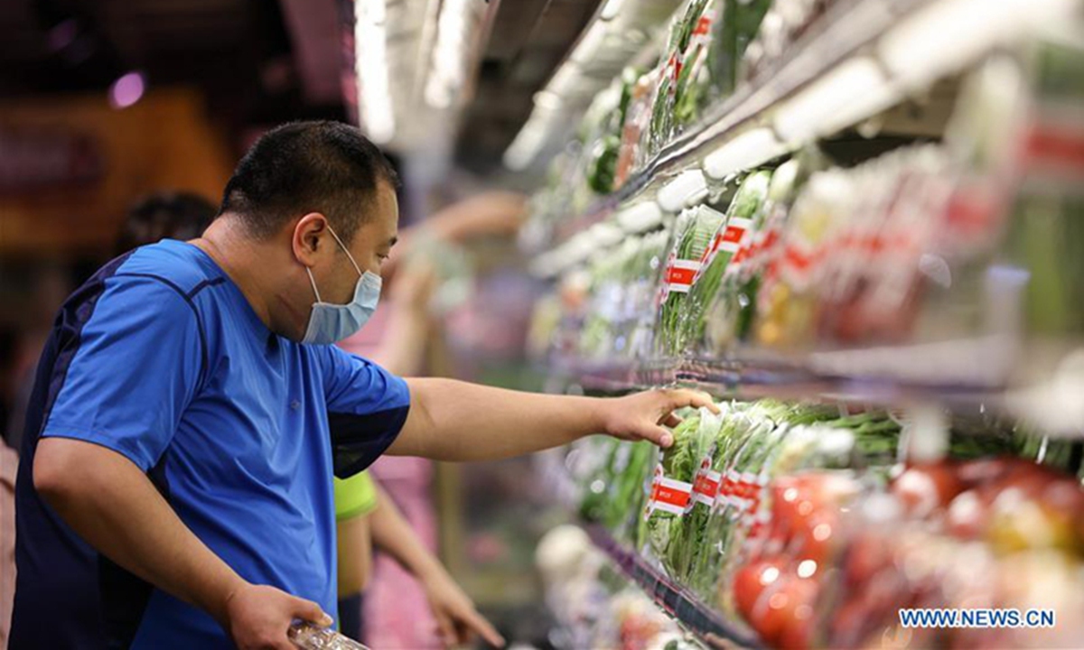 A man selects vegetables at a supermarket in Changchun, Northeast China's Jilin province. Photo: Xinhua