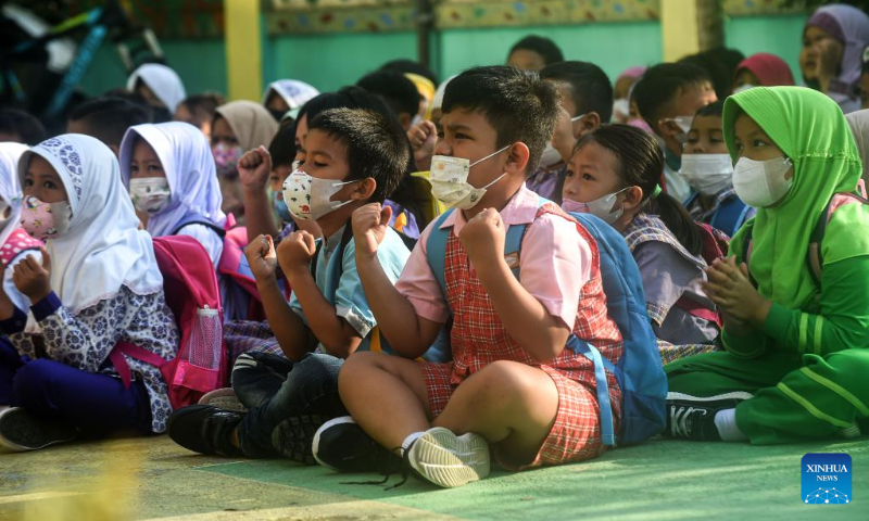 Students participate in a game during the first-day orientation of school year 2022-2023 at Jombang elementary school in South Tangerang of Banten Province, Indonesia, July 11, 2022. (Xinhua/Agung Kuncahya B.)
