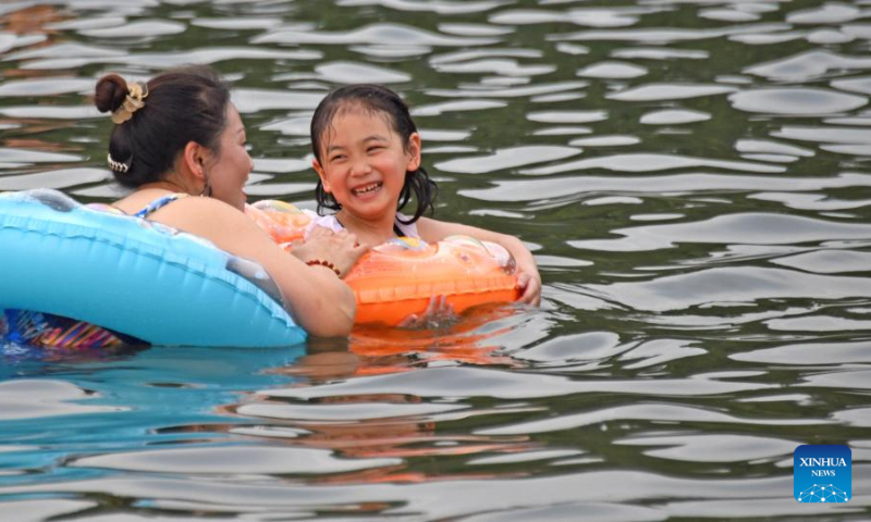 Photo taken on July 16, 2022 shows people playing in water in Xianju County of Taizhou City, east China's Zhejiang Province. (Xinhua/Wang Huabin)