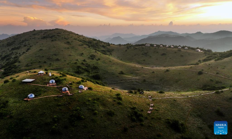 Aerial photo shows the grassland scenery of Bashan Mountain in Langao County, northwest China's Shaanxi Province, July 14, 2022. (Xinhua/Tao Ming)