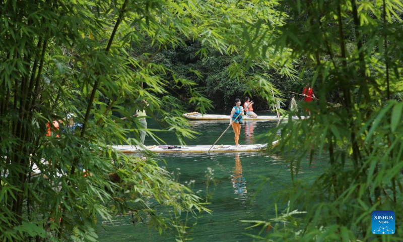 Photo taken on July 16, 2022 shows visitors experiencing bamboo rafting at Sanxia Bamboo Scenic Resort in Zigui County of Yichang City, central China's Hubei Province. (Xinhua/Wang Gang)