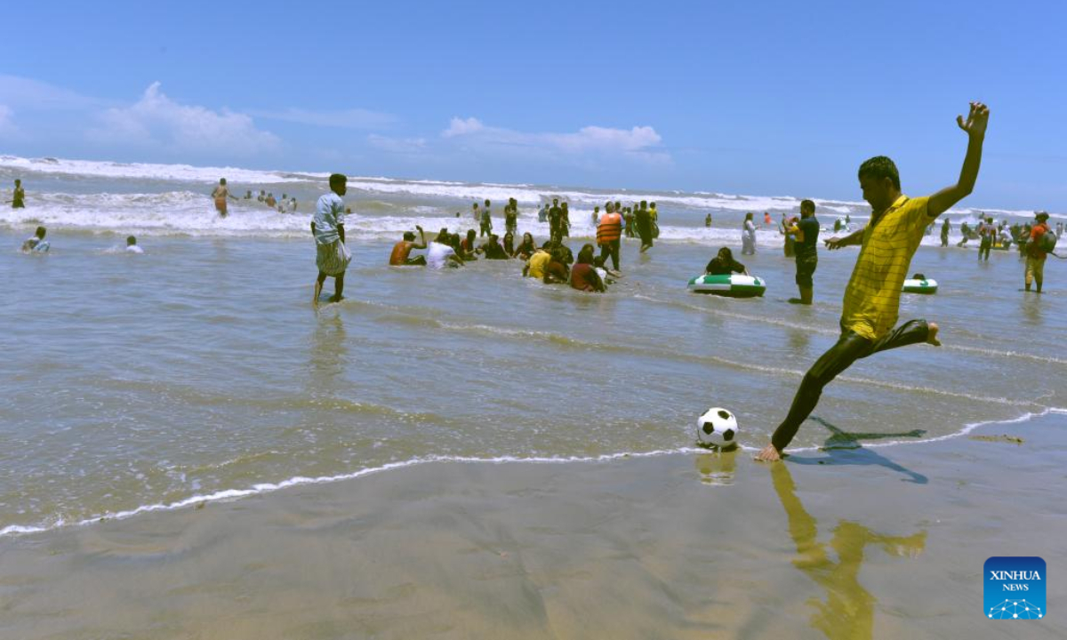 A man plays soccer at a beach during Eid al-Adha holiday in Cox's Bazar, Bangladesh, July 12, 2022. Photo:Xinhua