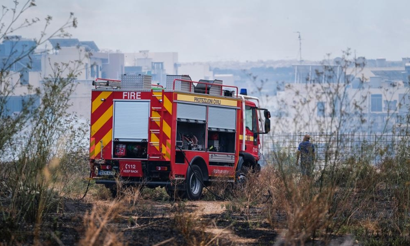 A fire truck is seen at a field in Iklin, a small town in central Malta, on July 10, 2022.Photo:Xinhua