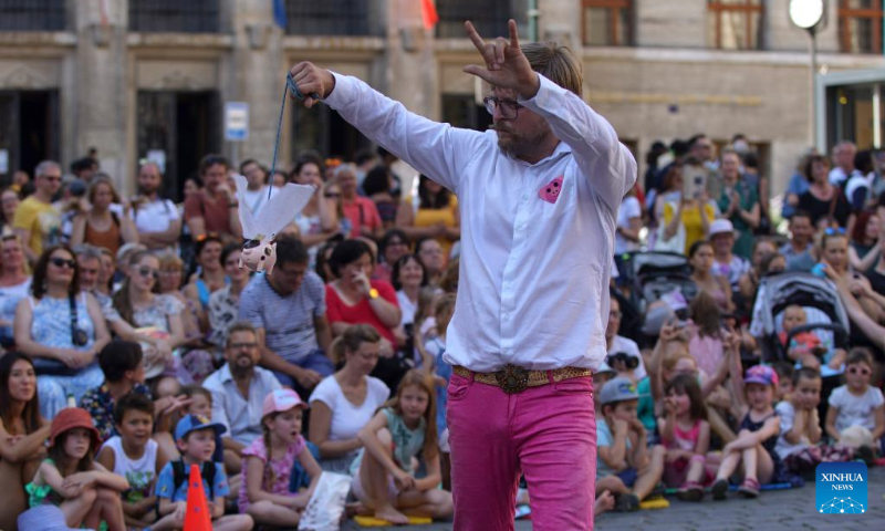 An artist performs during the 14th Prague Street Theater Festival in Prague, the Czech Republic, July 19, 2022. The week-long festival, which saw more than 40 performances by artists from several countries, closed Tuesday in the Czech capital. (Photo by Dana Kesnerova/Xinhua)