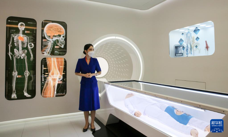 A guide explains an artificial intelligence doctor at the medical room aboard the 