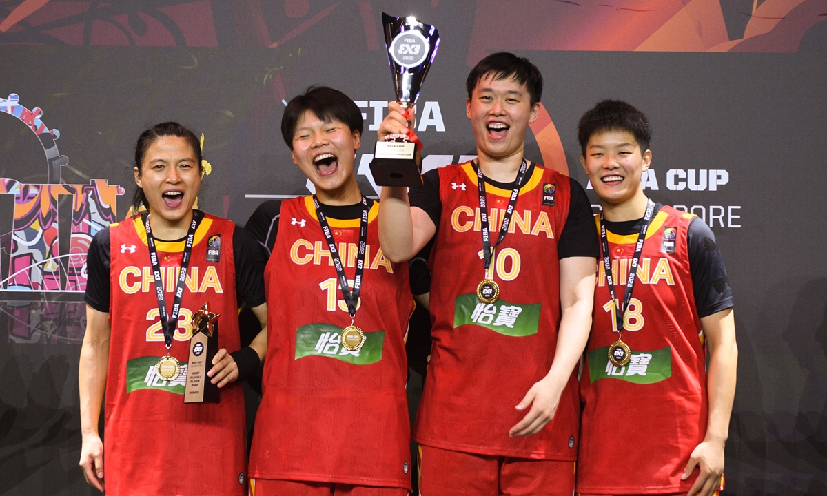 Wang Lili, Wan Jiyuan, Zhang Zhiting and Huang Kun (from left) of China celebrate during the awarding ceremony after winning the FIBA 3x3 Asia Cup women's final between China and Australia held in Singapore on July 10, 2022. Photo: Xinhua