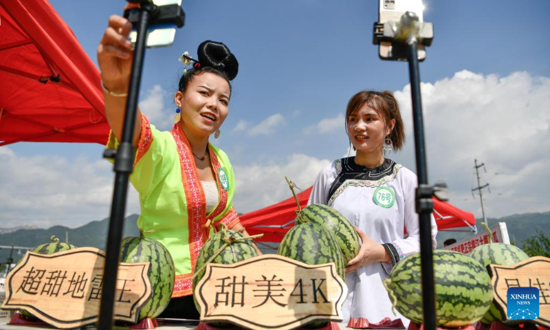 Livestreaming anchors promote watermelons during a watermelon festival held in Rongjiang County, southwest China's Guizhou Province, July 15, 2022. (Xinhua/Yang Wenbin)