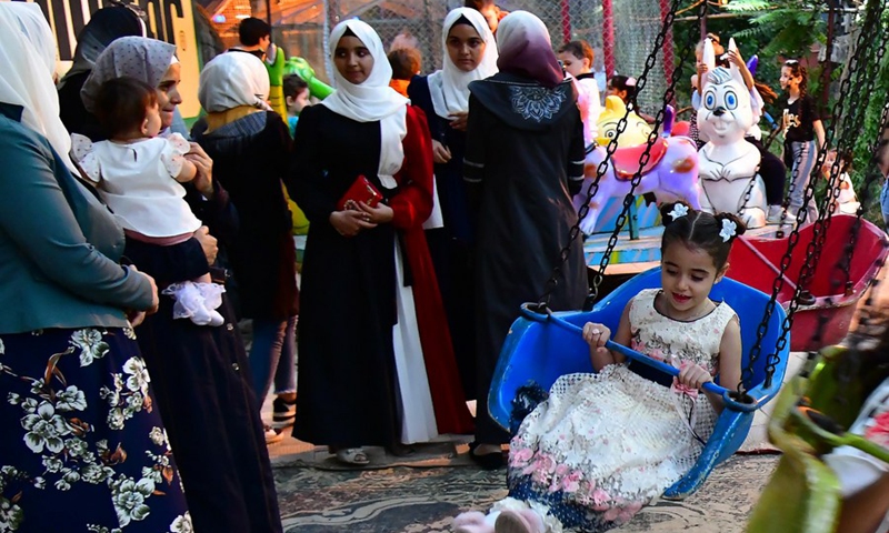 People spend time at a theme park during the Eid al-Adha holiday in Damascus, Syria, on July 10, 2022.(Photo: Xinhua)