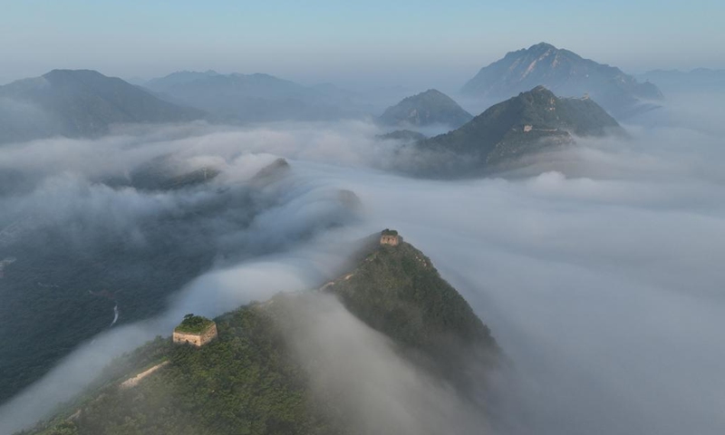 Aerial photo taken on July 11, 2022 shows clouds floating over a section of the Great Wall in Qianxi County, north China's Hebei Province.(Photo: Xinhua)