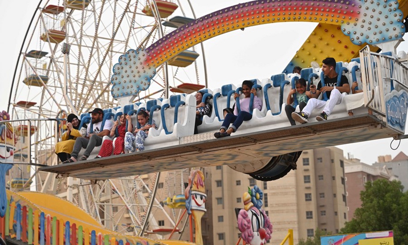 People spend time at an amusement park during the Eid al-Adha holiday in Hawally Governorate, Kuwait, on July 10, 2022.(Photo: Xinhua)