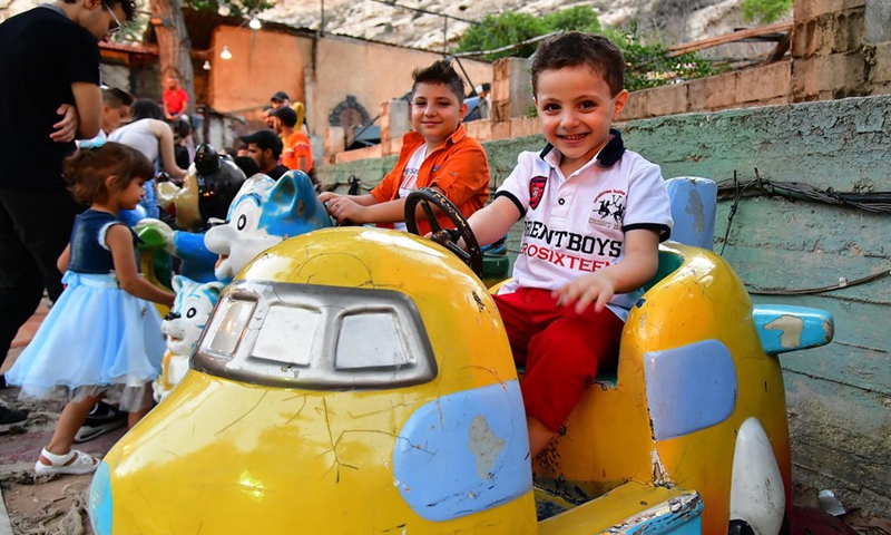 Children spend time at a theme park during the Eid al-Adha holiday in Damascus, Syria, on July 10, 2022.(Photo: Xinhua)