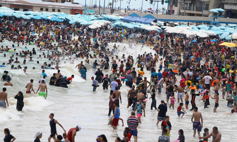 People spend time at the seaside during the Eid al-Adha holiday in Alexandria, Egypt, on July 11, 2022.(Photo: Xinhua)