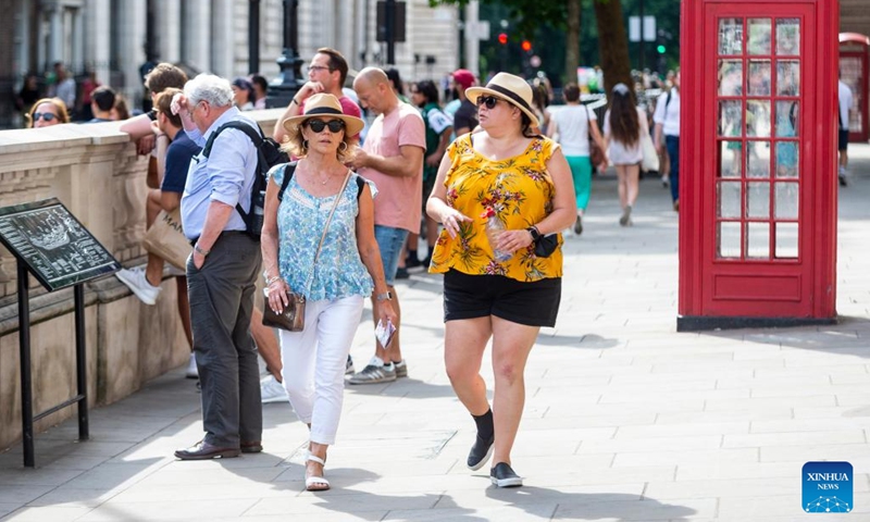 Tourists walk in Parliament Square in London, Britain, July 11, 2022. London is currently experiencing a heatwave as temperature hit a high of 32 degrees Celsius in west London on Monday.(Photo: Xinhua)