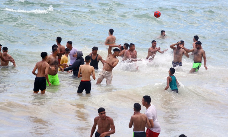 People spend time at the seaside during the Eid al-Adha holiday in Alexandria, Egypt, on July 11, 2022.(Photo: Xinhua)