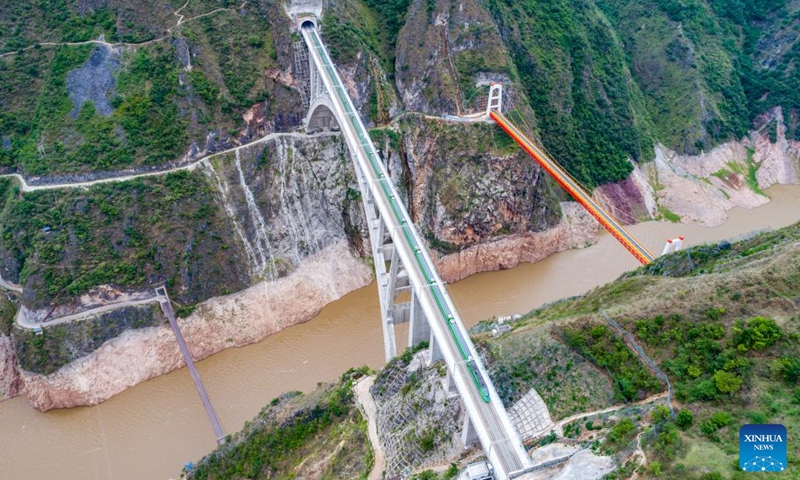 In this aerial photo, a bullet train runs on the Lancang River super major bridge along the Dali-Baoshan section of Dali-Ruili Railway in southwest China's Yunnan Province, July 19, 2022. The Dali-Baoshan section of Dali-Ruili Railway will soon be put into operation, putting an end to Baoshan's status as a place with no rail links.(Photo: Xinhua)