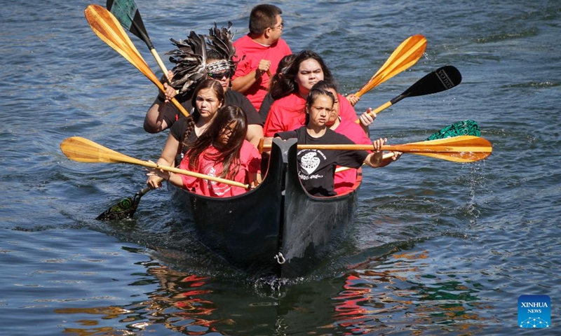 Indigenous people paddle during a canoe arrival ceremony at False Creek in Vancouver, British Columbia, Canada, on July 14, 2022. Indigenous people participated in the canoe arrival ceremony on Thursday to mark the opening of the Sacred Journey exhibition at Science World in Vancouver. The Sacred Journey is an exhibition showcasing Northwest Coast canoe cultures and the indigenous people's way of life. (Photo: Xinhua)
