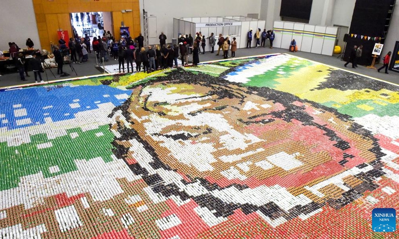 People use food cans to lay out a mosaic in the shape of Nelson Mandela's portrait to mark International Nelson Mandela Day in Cape Town, South Africa, on July 18, 2022.(Photo: Xinhua)