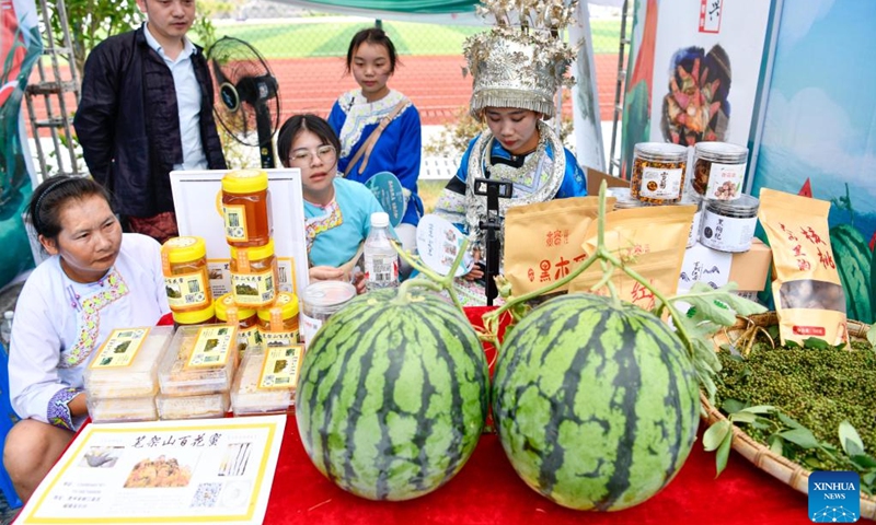 Watermelons and other agricultural products are seen during a watermelon festival held in Rongjiang County, southwest China's Guizhou Province, July 15, 2022. Recently, Rongjiang County has held various watermelon festivals to help farmers promote watermelon sales during the harvest season. In the past few years, new watermelon varieties were introduced to Rongjiang to boost villagers' income and local economy.(Photo: Xinhua)