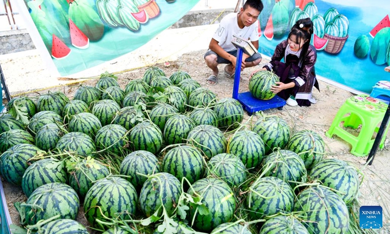 Villagers promote watermelons during a watermelon festival held in Rongjiang County, southwest China's Guizhou Province, July 15, 2022. Recently, Rongjiang County held various festivals of watermelons to help farmers promote watermelon sales during the harvest season.  In recent years, new varieties of watermelon have been introduced to Rongjiang to boost villagers' incomes and the local economy.  (Photo: Xinhua)