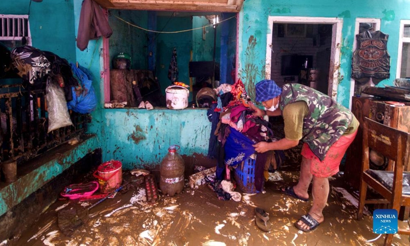 A man cleans his house after flood in Garut, West Java, Indonesia, July 16, 2022.Photo:Xinhua