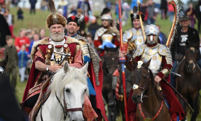 Enthusiasts dressed as knights are seen in action during a reenactment of the Battle of Grunwald, in Grunwald, Poland, on July 16, 2022.Photo:Xinhua