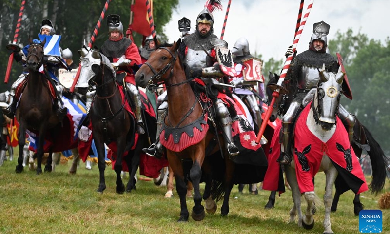 Enthusiasts dressed as knights are seen in action during a reenactment of the Battle of Grunwald, in Grunwald, Poland, on July 16, 2022.Photo:Xinhua