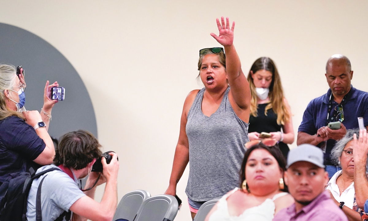 Tina Quintanilla-Taylor, a mother of a survivor of the shootings at Robb Elementary School, raises her hand and voice as she tries to ask the Texas House investigative committee a question at a news conference after they released a full report on the shootings on July 17, 2022, in Uvalde, Texas. Photo: VCG