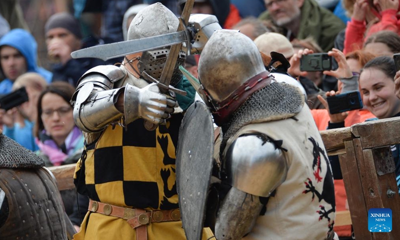 Enthusiasts dressed as knights are seen in action during a reenactment of the Battle of Grunwald, in Grunwald, Poland, on July 16, 2022.Photo:Xinhua