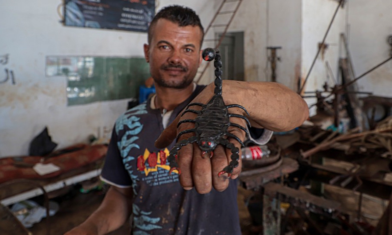 Fakher Hamad, a hearing impaired Palestinian, displays his work made of iron at his workshop in Beit Hanoun town in the northern Gaza Strip, on July 18, 2022.(Photo: Xinhua)