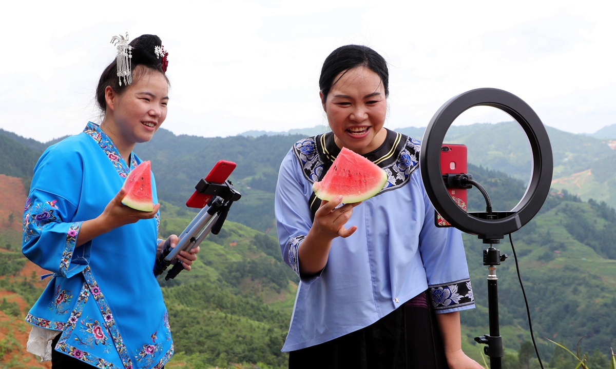Farmers promote locally produced watermelons via livestreaming in a county in Southwest China's Guizhou Province. E-commerce in rural areas plays an increasingly important role in enriching local communities. Online sales of agricultural products reached 422.1 billion yuan ($62.49 billion) in 2021, up 2.8 percent year-on-year. Photo: VCG