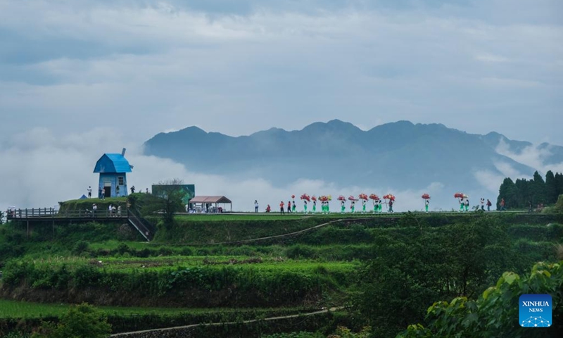 In this aerial photo, villagers celebrate in traditional costumes as they start ploughing and release fish fry into rice fields in Xiaozhoushan Township, Qingtian County, east China's Zhejiang Province, June 11, 2020. The rice-fish co-culture system in Qingtian has a history of more than 1,300 years and was listed in the world's first group of the Globally Important Agricultural Heritage Systems (GIAHS) designated by the Food and Agriculture Organization of the United Nations (FAO) in 2005.(Photo: Xinhua)